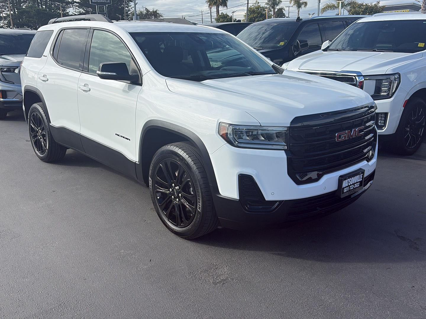 2023 GMC Acadia SLE in Summit White — front three-quarter view