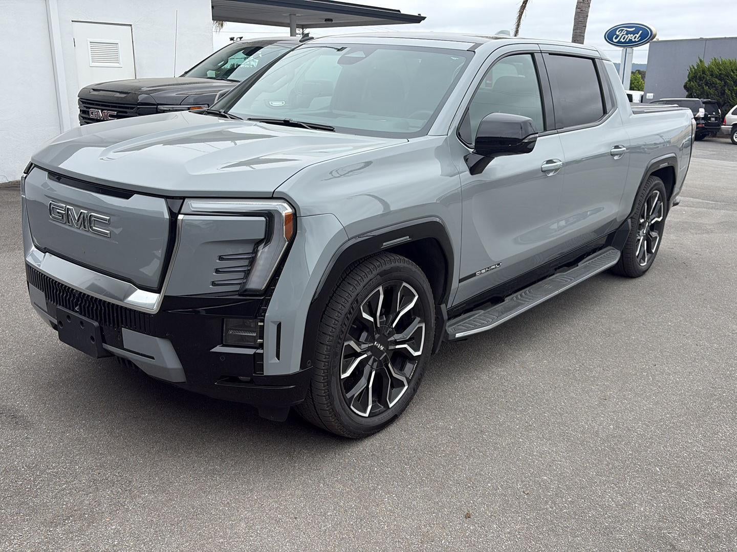 2025 GMC Sierra EV Extended Range Denali in Thunderstorm Gray — front three-quarter view