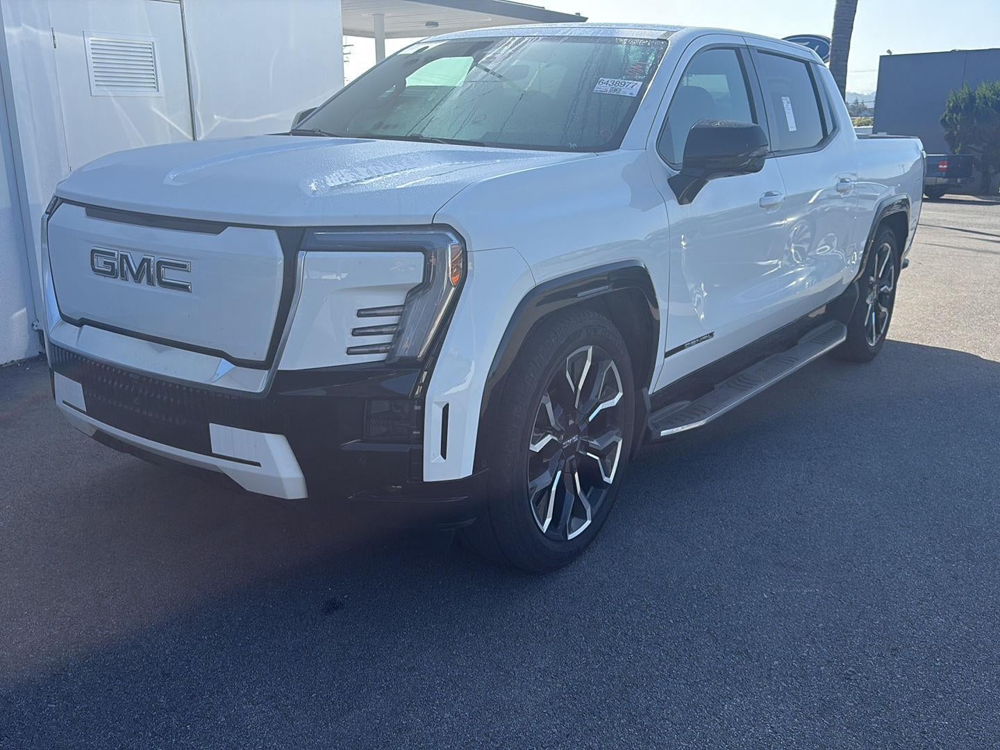 2025 GMC Sierra EV Extended Range Denali in Summit White — front three-quarter view