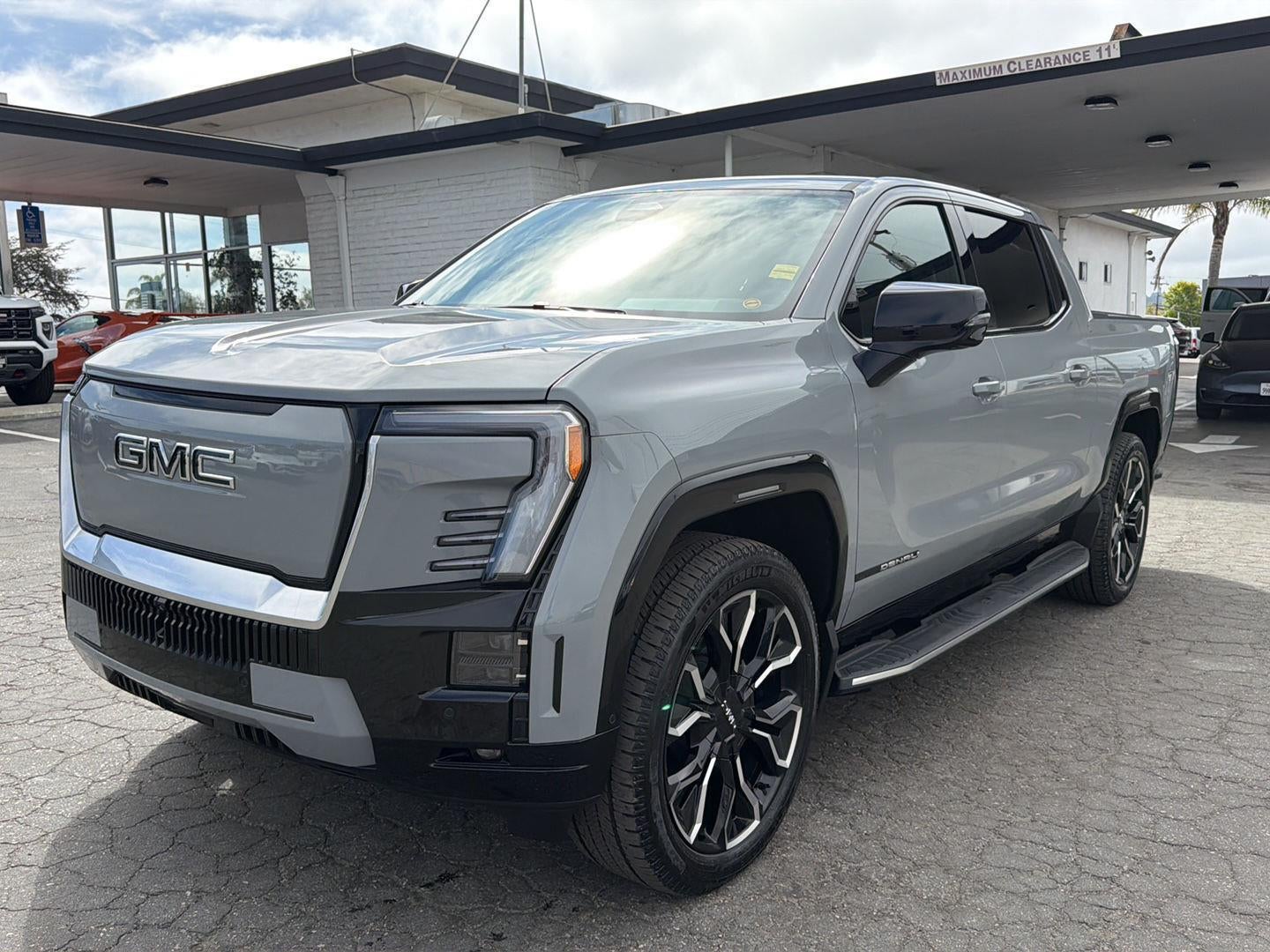 2024 GMC Sierra EV Denali Edition 1 in Thunderstorm Gray — front three-quarter view