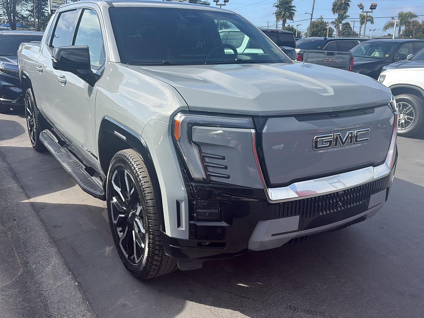 2024 GMC Sierra EV Denali Edition 1 in Thunderstorm Gray — front three-quarter view