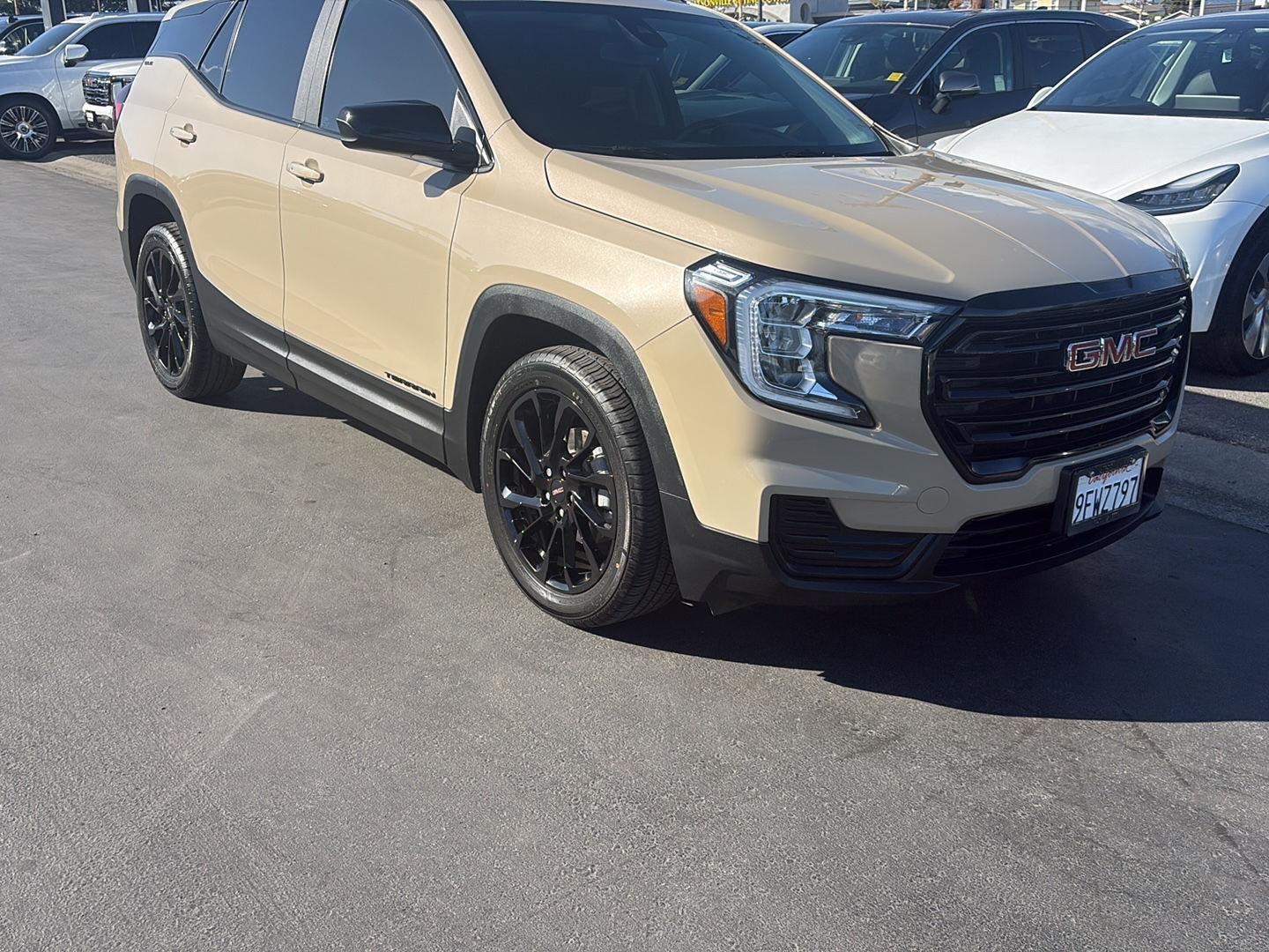 2023 GMC Terrain SLE in Desert Sand Metallic — front three-quarter view