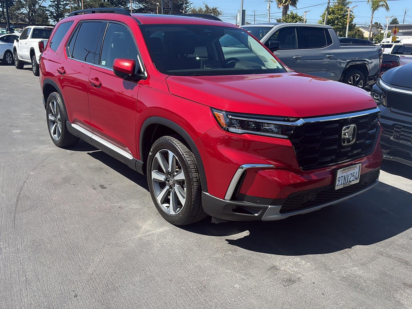 2025 Honda Pilot Elite in Red — front three-quarter view