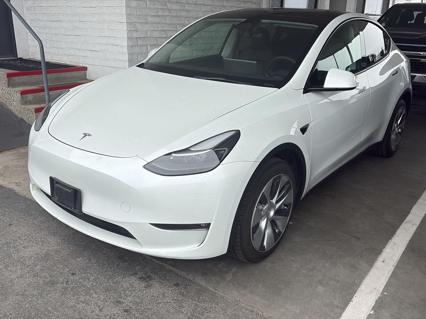2023 Tesla Model Y Long Range in White — front three-quarter view